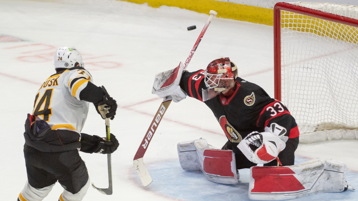 Boston Bruins forward Jake DeBrusk and Ottawa Senators goalie Cam Talbot
