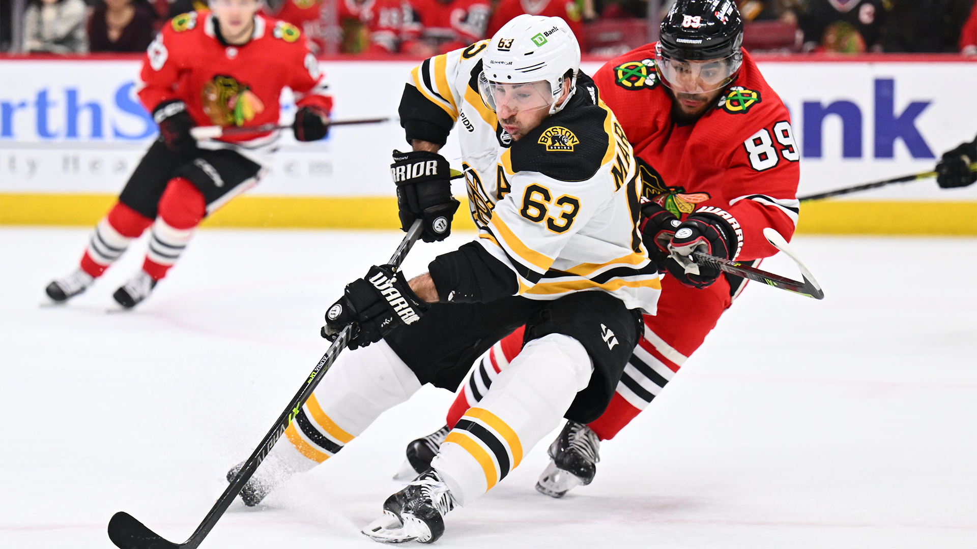 Boston Bruins forward Brad Marchand and Chicago Blackhawks forward Andreas Athanasiou