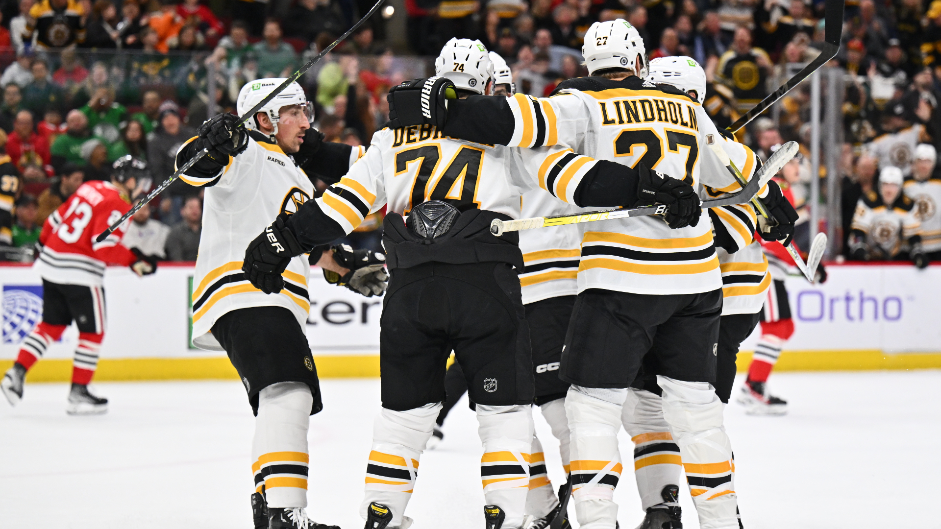 Boston Bruins defenseman Hampus Lindholm, forwards Brad Marchand, Jake DeBrusk