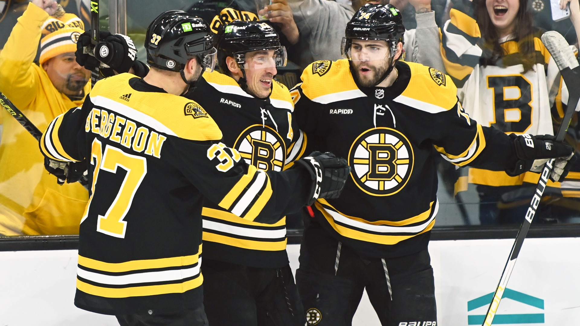 Boston Bruins forwards Patrice Bergeron, Brad Marchand, Jake DeBrusk