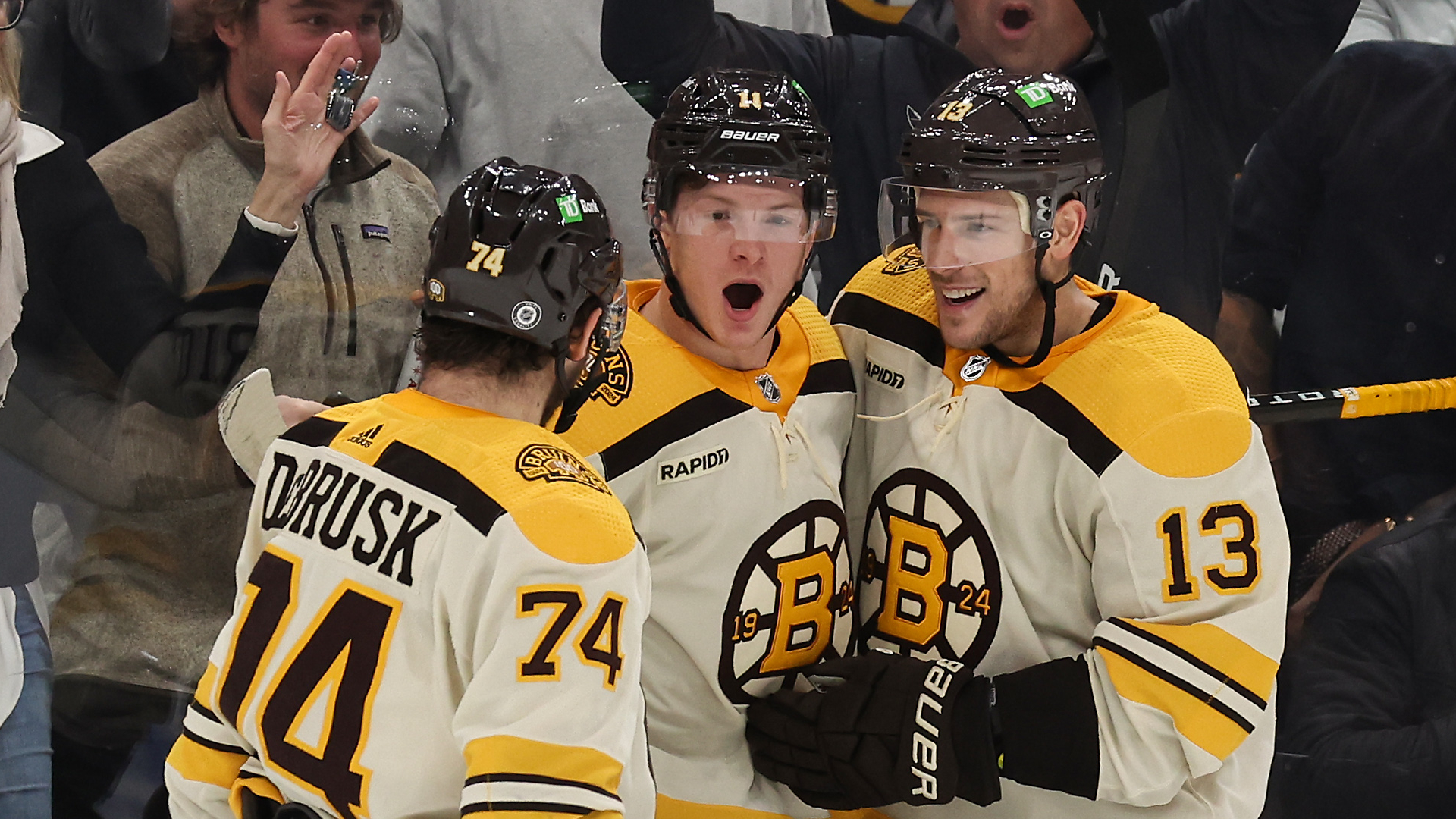 Boston Bruins forwards Jake DeBrusk, Trent Frederic and Charlie Coyle