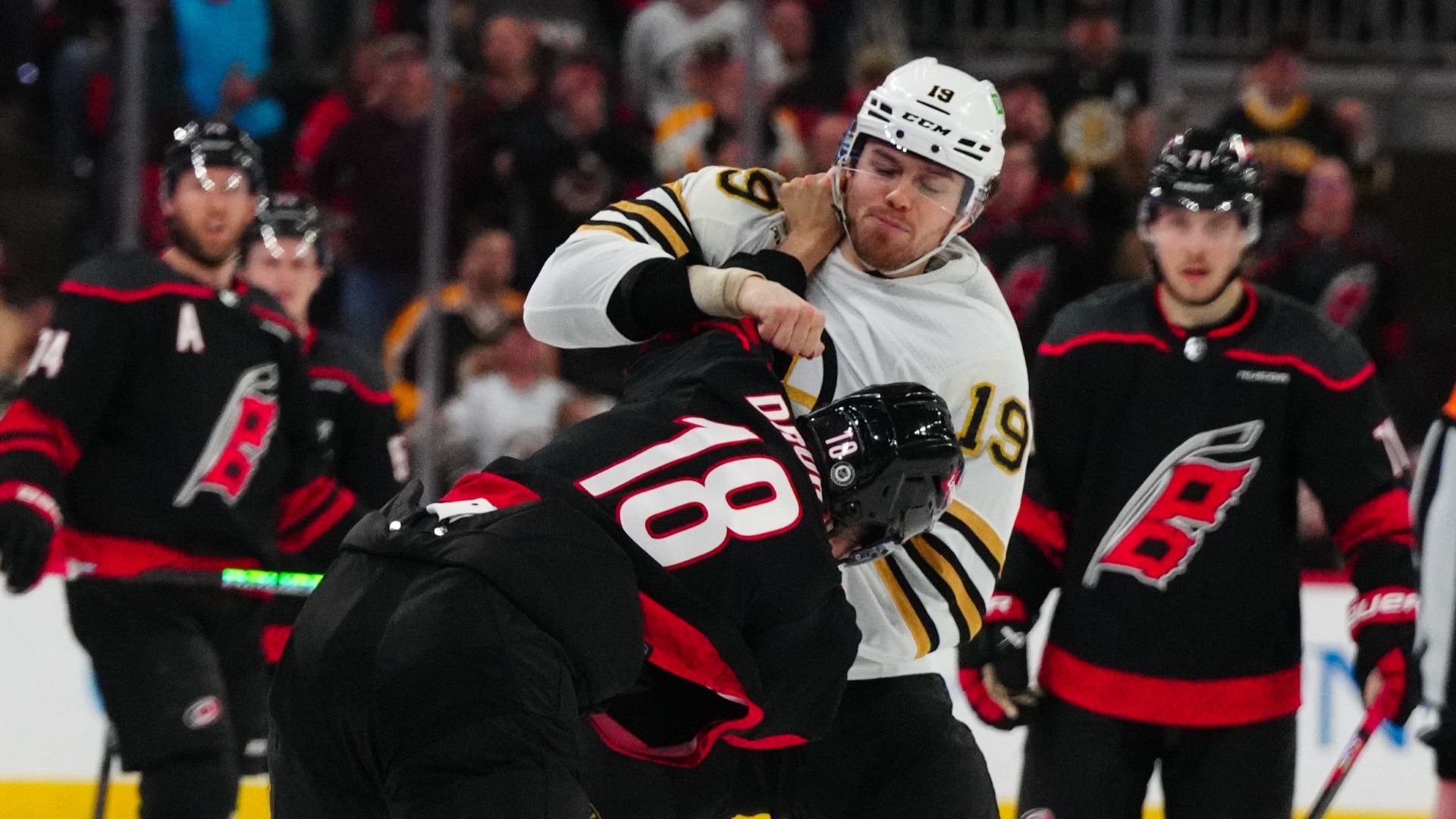 Boston Bruins forward John Beecher and Carolina Hurricanes forward Jack Drury