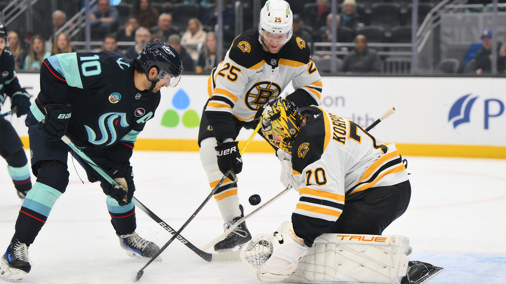 Boston Bruins defenseman Brandon Carlo and goaltender Joonas Korpisalo, Seattle Kraken forward Matty Beniers